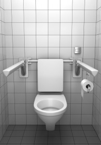 toilet for invalids with white tile on wall